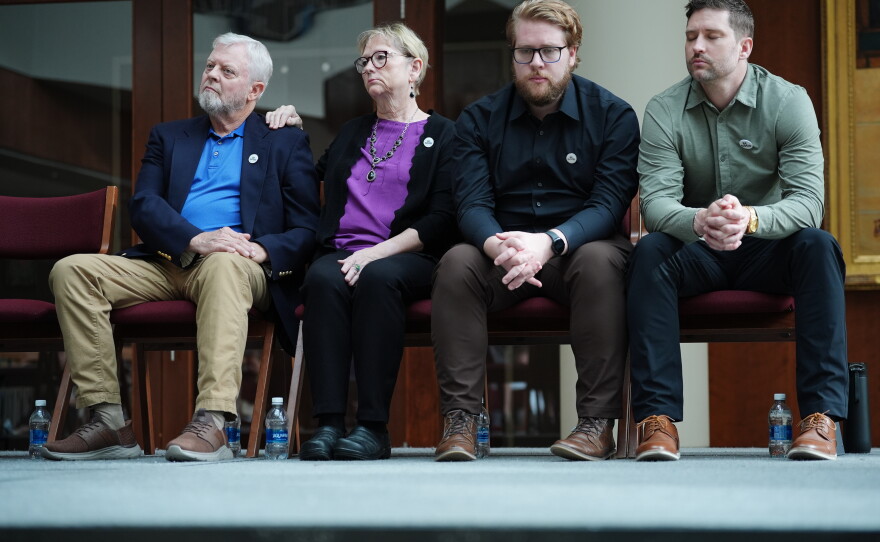 The family of Renee Good, from left; father Tim Ganger, mother Donna Ganger, brother Luke Ganger and brother Brent Ganger, listen during a news conference after the family sued the U.S. government and several immigration officials, Thursday, Oct. 1, 2026, in Minneapolis.