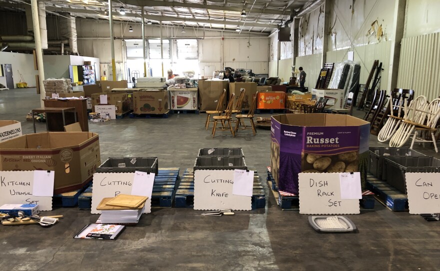 Donated items are sorted in a warehouse for incoming families.
