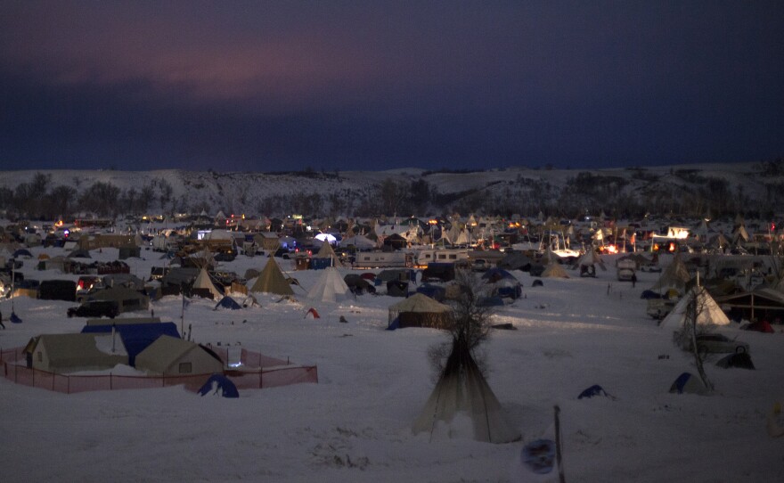 Though emergency evacuation orders have been issued by both the state of North Dakota and the Army Corps of Engineers, the three camps along the Cannonball River, now covered in snow, show no sign of packing up.