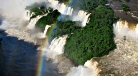 Spray high over Iguaçu Falls, on the border of Brazil and Paraguay, creates a rainbow. The Falls, one of the wonders of the natural world, symbolizes the power of falling water as a potential source of clean energy.