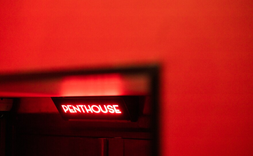 A sign for Penthouse, a strip club in the basement of a building, that also serves as a shelter in Kyiv.