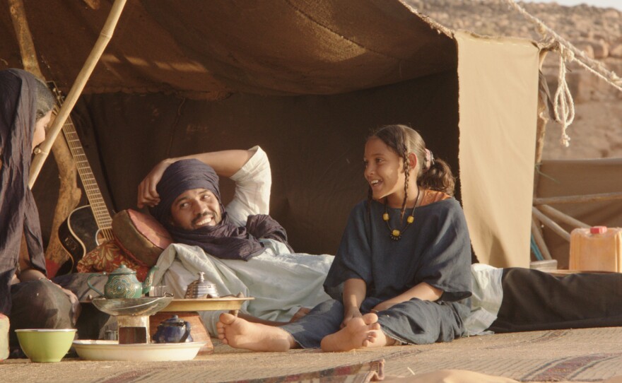 In the movie, the cattle herder Kidane (center, played by Ibrahim Ahmed) and his family live in a tent in the mountains near Timbuktu.