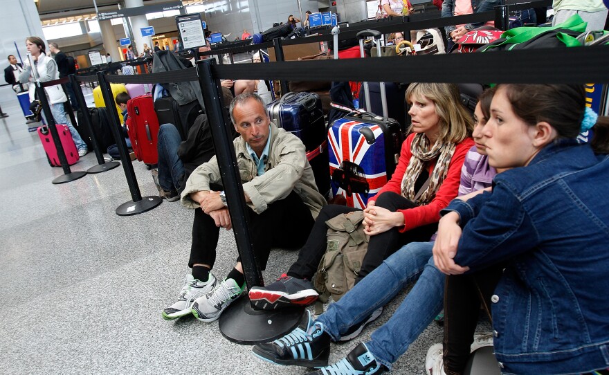 From left, Alphonse Roig, his wife Christine Roig, and daughters Nanine and Lana, wait for the British Airways counter to reopen. The family was trying to make it home to France.