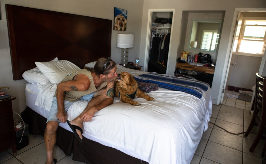 Arley Adcock is shown with his dog Cheyenne at a hotel in San Diego where he currently living, June 9, 2022.