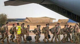 French soldiers who wrapped up a four-month tour of duty in the Sahel board a U.S. Air Force C-130 transport plane, leave their base in Gao, Mali on Wednesday, June 9, 2021.
