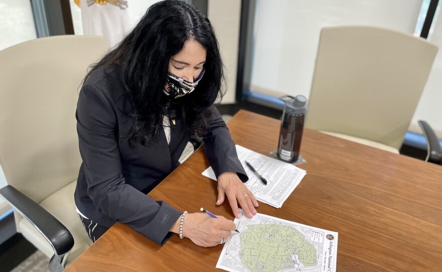 Arlington National Cemetery Executive Director Karen Durham-Aguilera points out on a map where the cemetery's newest expansion will add over 80,000 new burial opportunities. Despite the 37 acre expansion, Durham-Aguilera said cuts to eligibility are also required to keep the cemetery operating.