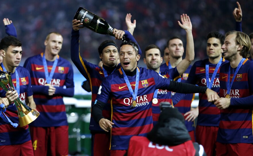 Futbol Club Barcelona's Neymar da Silva Santos pours champagne over Adriano as their team won the final match against River Plate at the FIFA Club World Cup soccer tournament in Yokohama, near Tokyo, on Dec. 20.