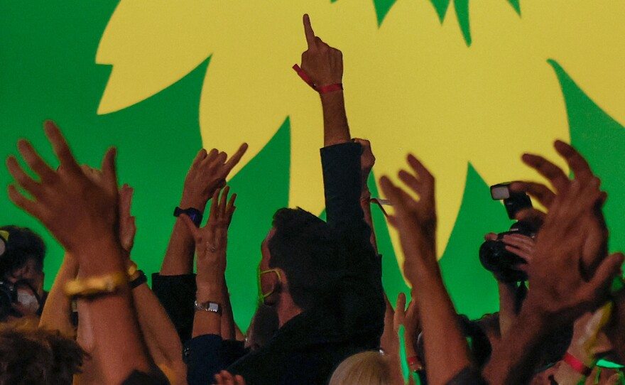 Supporters of Germany's Green Party celebrate after estimates were broadcast on television in Berlin at their electoral party on Sunday after the German general elections.