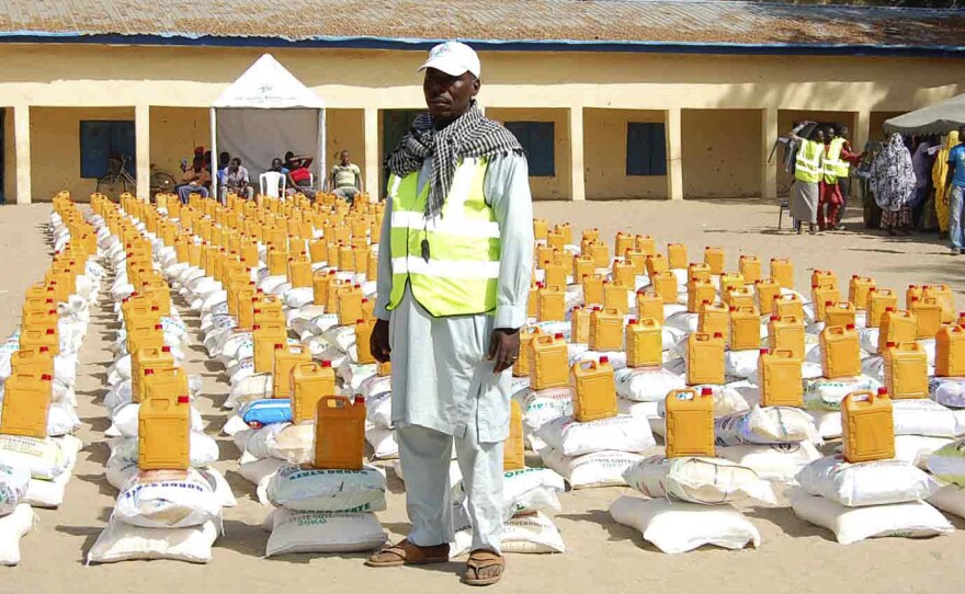 An official stands in front of relief materials at a camp for displaced people in Maiduguri in Borno State last week. The town, where many have gathered after fleeing Boko Haram attacks, is now said to be under assault from the Islamist extremist group.