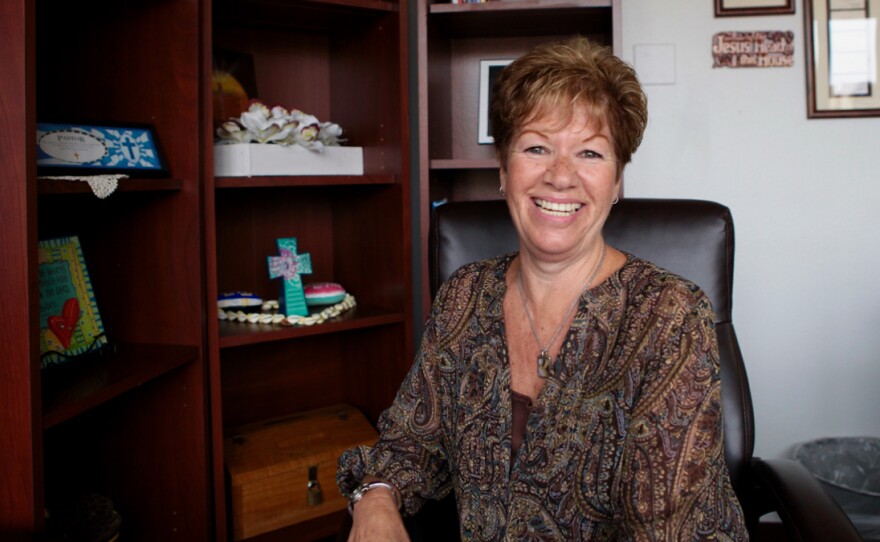 Teresa Whitney sits in front of crosses and other religious signs at the Salvation Army's office. She is a rehabilitation manager for the nonprofit. Sept. 21, 2016.