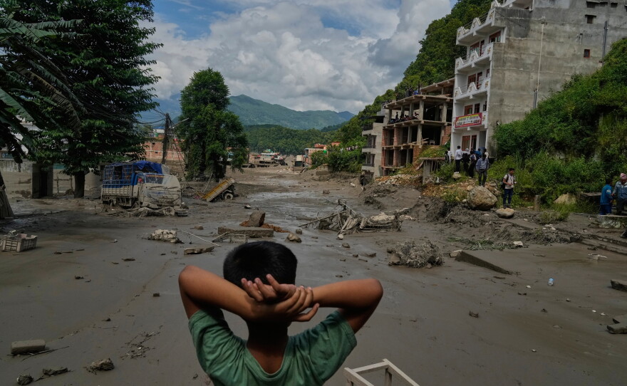 A boy looks at the devastation caused by flash flooding along the Trishuli River in Nepal's Nuwakot district on Wednesday.