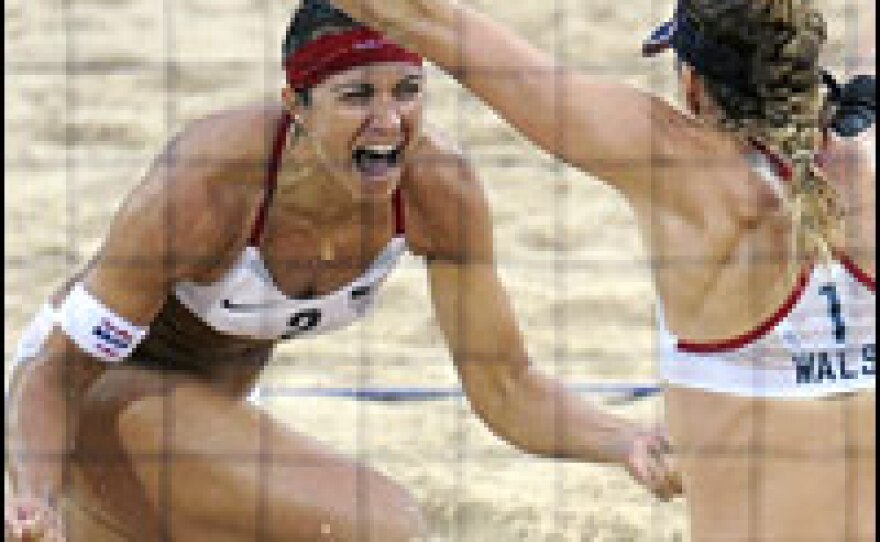 Americans Misty May-Treanor (left) and Kerri Walsh celebrate their Olympic gold medal victory over China's Tian Jia and Wang Jie in women's beach volleyball in Beijing.