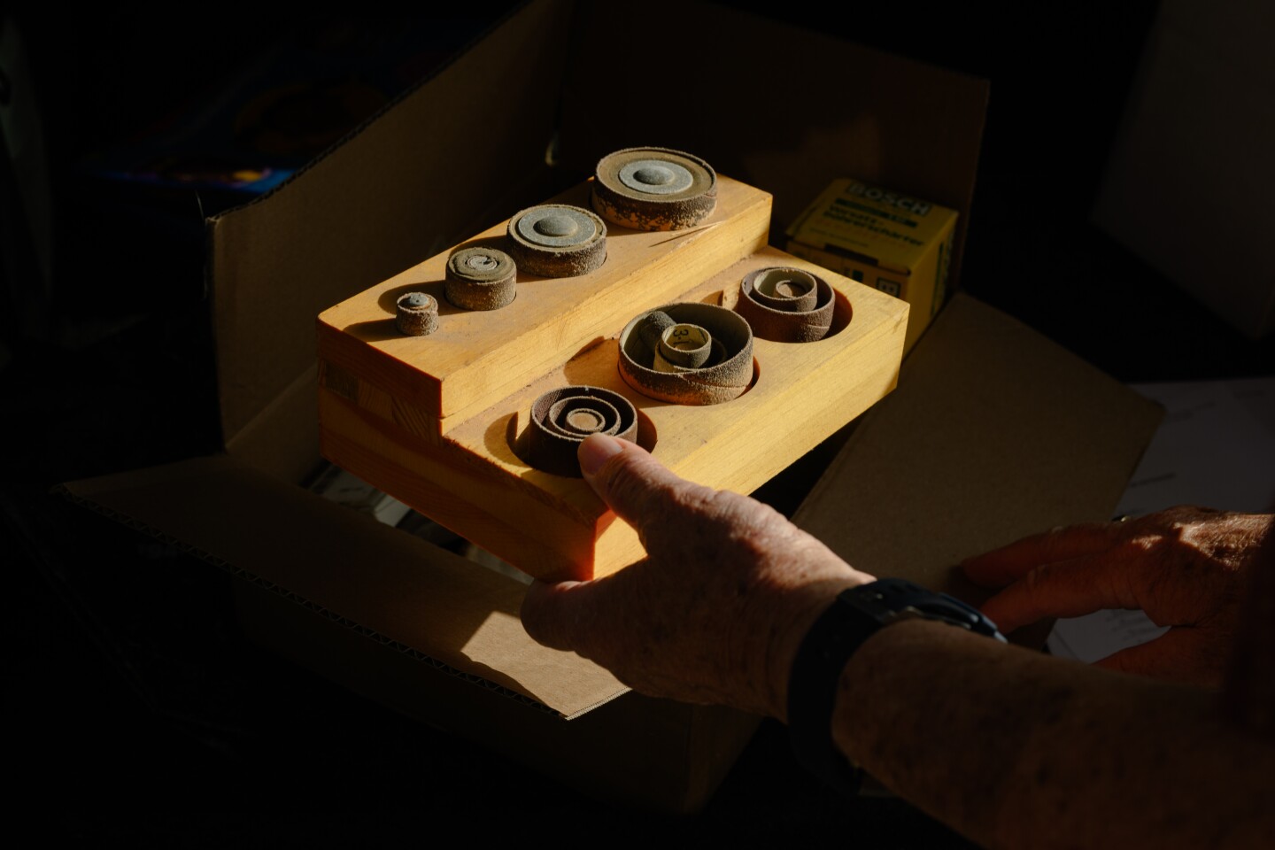 Spring Valley resident Martin Angell holds a box of sandpaper along with other donations that he brought to the National City Public Library in National City, California for u-Tool-ize, the library's new tool lending program on October 13, 2025.