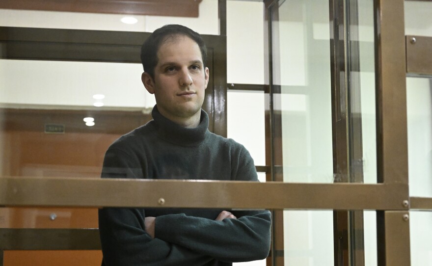 <em>Wall Street Journal</em> reporter Evan Gershkovich stands in a glass cage in a courtroom at the Moscow City Court on Thursday. The court upheld an earlier ruling to hold Gershkovich in pre-trial detention until at least Jan. 30, 2024.