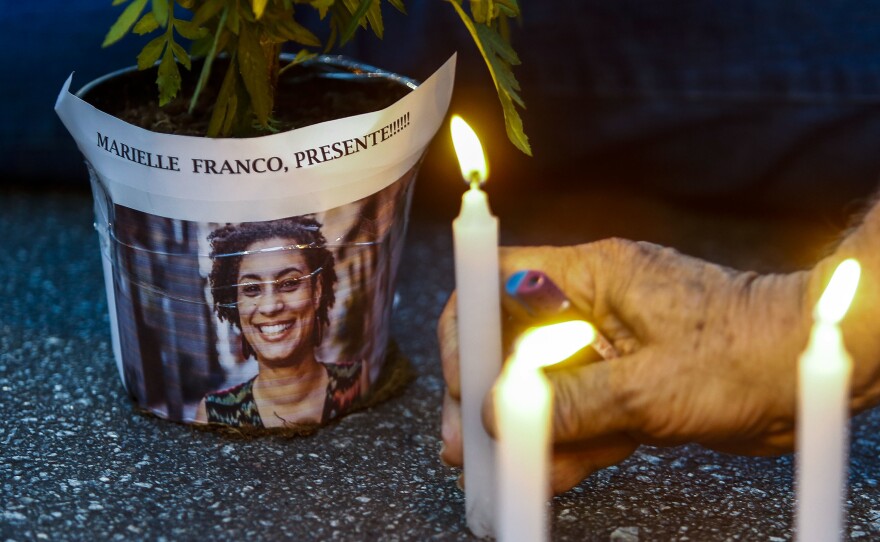 An elderly man lights a candle during a rally against the murder of Brazilian councilwoman and activist Marielle Franco, in Sao Paulo Brazil on March 15, 2018. Brazilians mourned for the Rio de Janeiro councilwoman and outspoken critic of police brutality who was shot in the city center in an assassination-style killing.