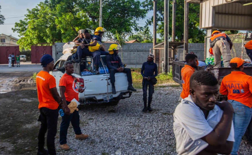 <strong data-stringify-type="bold">Mon., Aug. 16: </strong>Civil protection workers and firefighters get ready to deploy humanitarian aid.