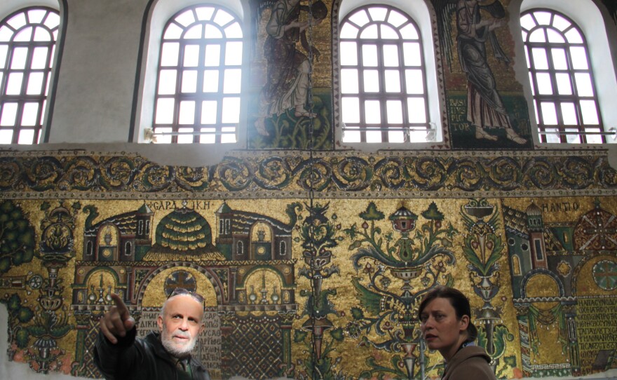 Engineer Imad Nassar, a Palestinian Christian from Bethlehem and technical manager for the Nativity Church restoration project, guides a journalist in the church.