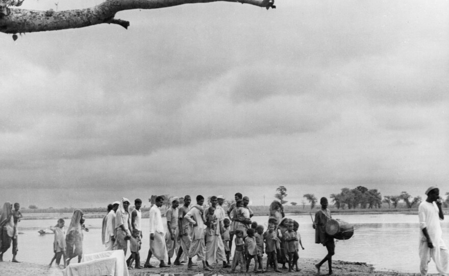 A village drummer announces the arrival of the tuberculosis vaccine during an immunization campaign in India in the 1950s.