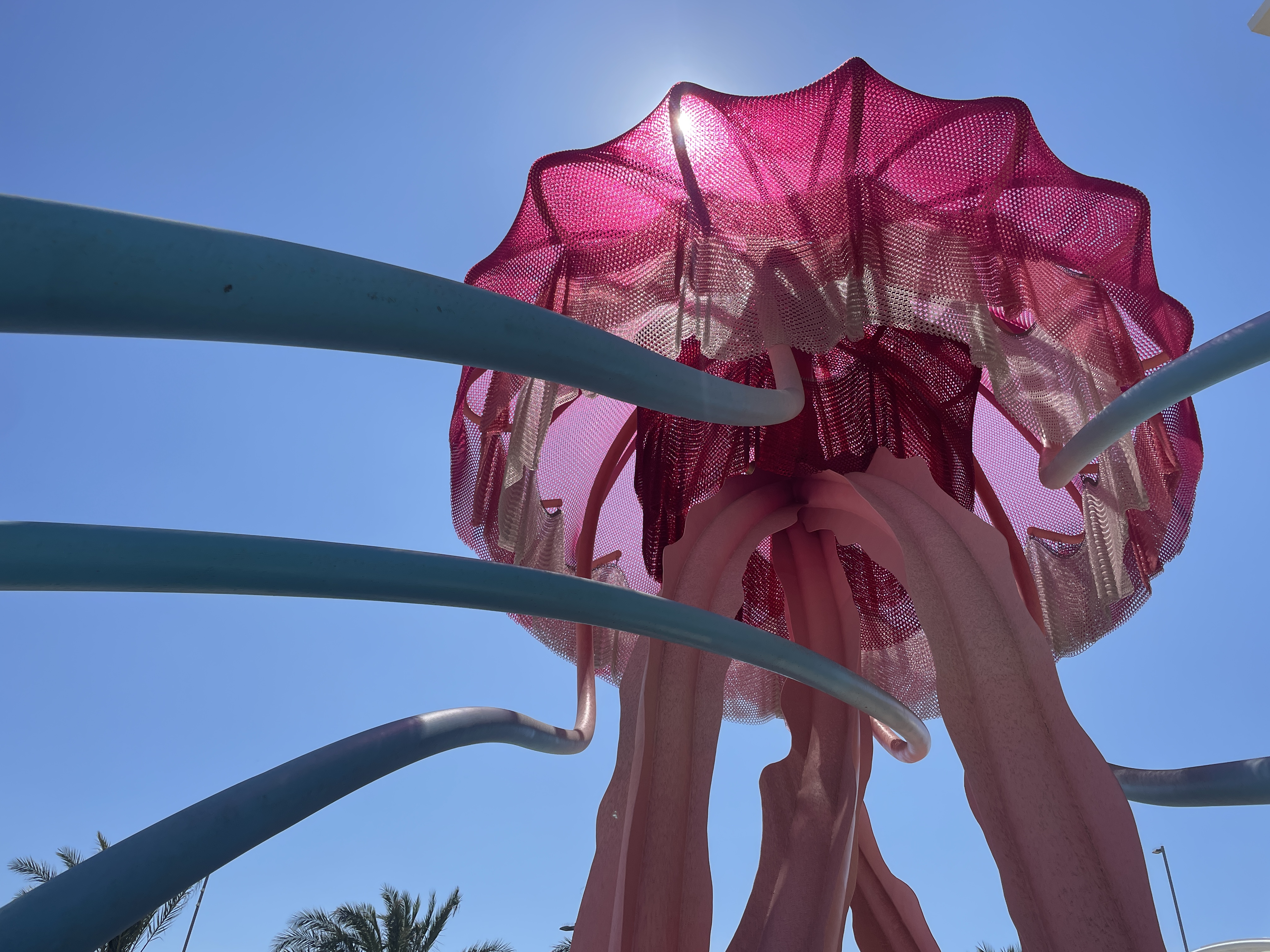 A giant pink jellyfish welcomes travelers at the airport's new